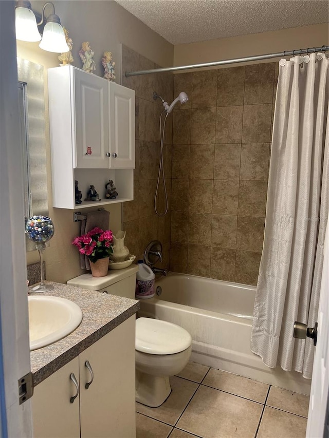 full bathroom featuring vanity, shower / bath combination with curtain, a textured ceiling, tile patterned flooring, and toilet