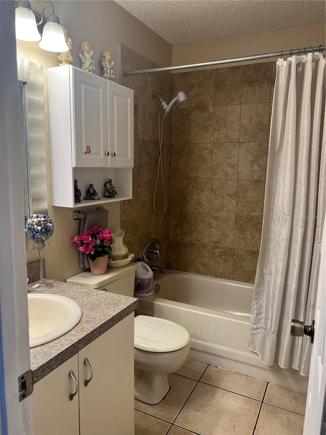 full bath with a textured ceiling, vanity, tile patterned flooring, toilet, and shower / bath combo with shower curtain