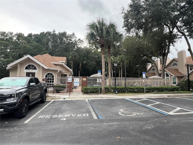 uncovered parking lot with fence and a gate