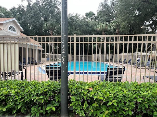 pool featuring a patio and fence