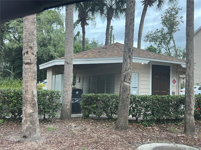 bungalow featuring roof with shingles