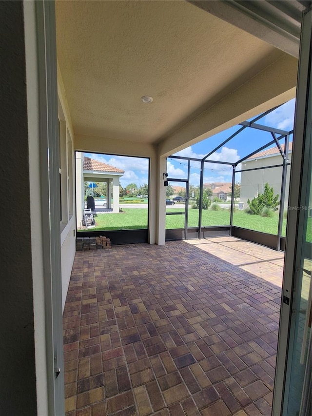 view of patio with glass enclosure