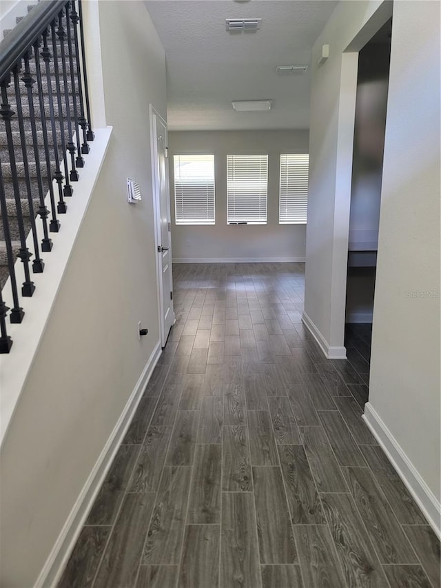 corridor featuring dark hardwood / wood-style flooring