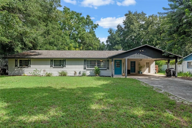 ranch-style house featuring a carport and a front yard