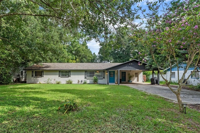 ranch-style house with a carport and a front lawn