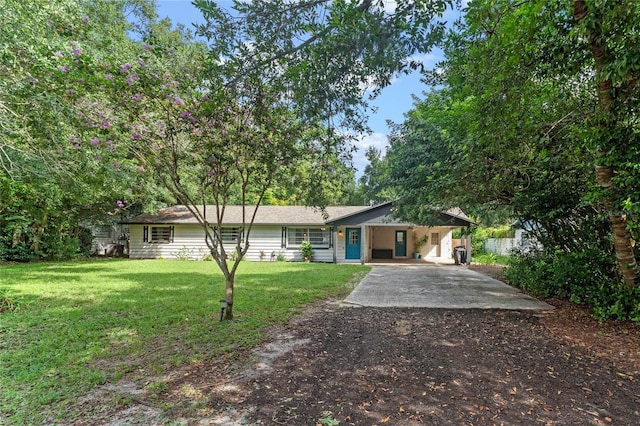 single story home featuring a front lawn and a carport