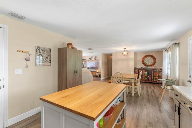 kitchen with light hardwood / wood-style flooring and a kitchen island