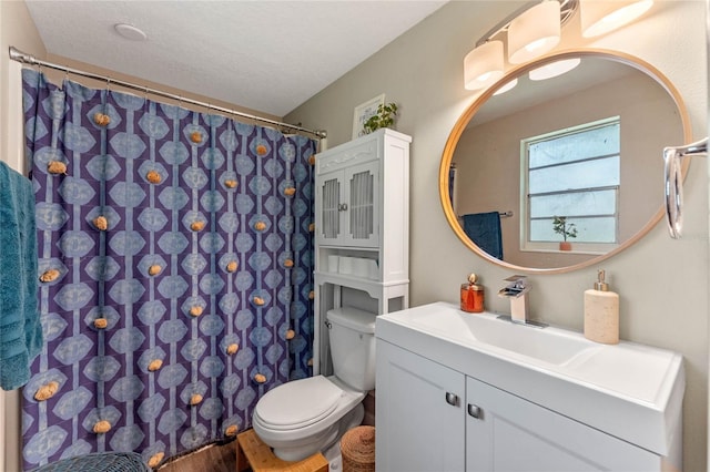 bathroom featuring vanity, toilet, a textured ceiling, walk in shower, and hardwood / wood-style floors