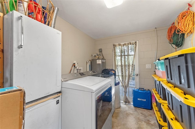 washroom with water heater and independent washer and dryer