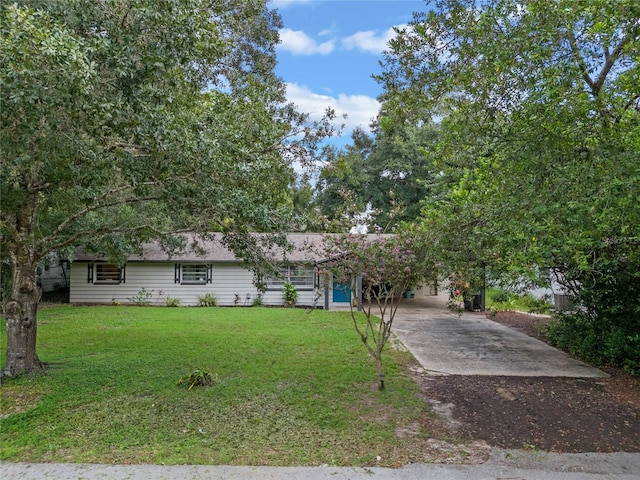 view of front facade with a front lawn and a carport