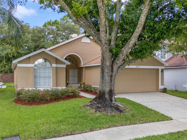 single story home with a front yard and a garage