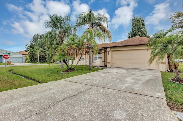 view of front of home featuring a garage and a front lawn