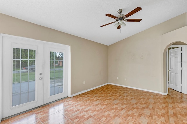 spare room with ceiling fan, a textured ceiling, and french doors