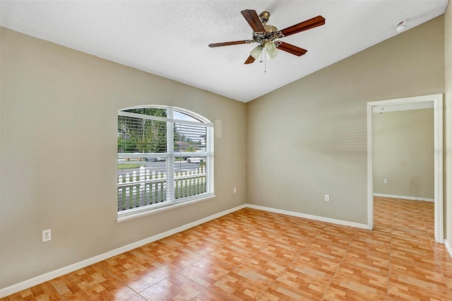 empty room featuring ceiling fan, a textured ceiling, and vaulted ceiling