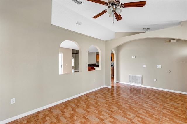 unfurnished room featuring a textured ceiling, lofted ceiling, and ceiling fan