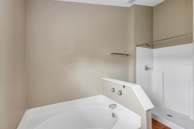 bathroom featuring shower with separate bathtub and hardwood / wood-style floors