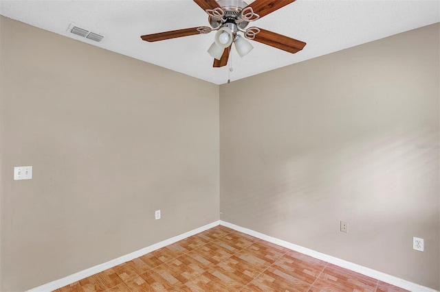 unfurnished room featuring ceiling fan, hardwood / wood-style floors, and a textured ceiling