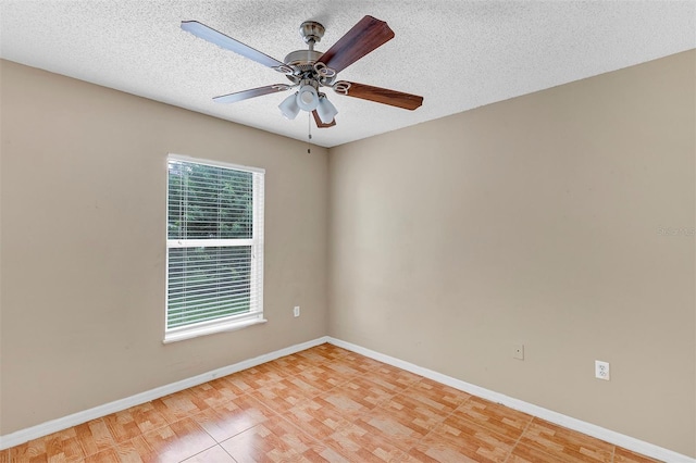 spare room with light hardwood / wood-style floors, ceiling fan, and a textured ceiling