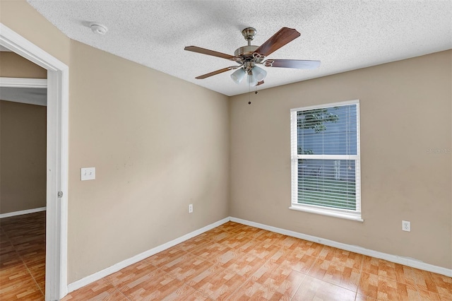 empty room with ceiling fan, a textured ceiling, and light wood-type flooring