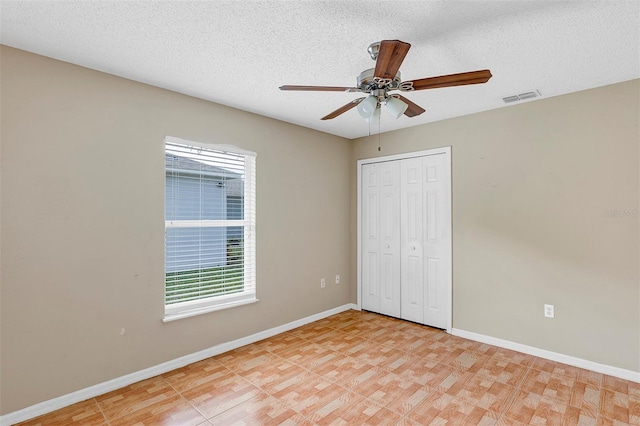 unfurnished bedroom featuring a closet, ceiling fan, and a textured ceiling