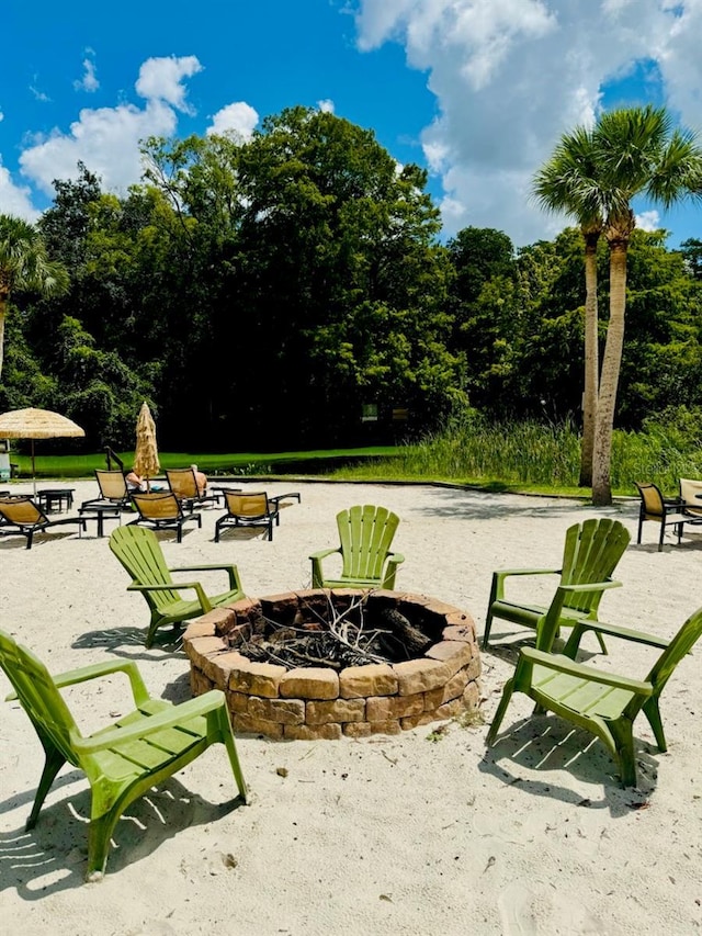 view of community featuring a fire pit and a patio