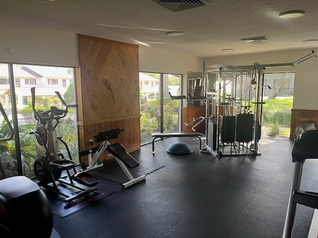 gym featuring a textured ceiling