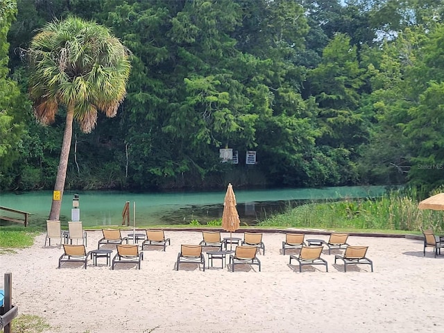 view of community featuring a forest view and a water view