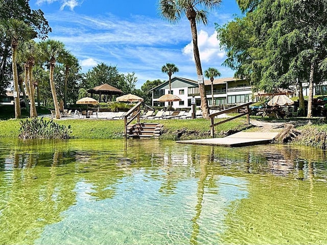 view of dock featuring a gazebo and a water view