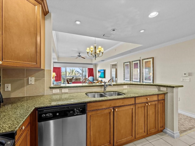 kitchen featuring brown cabinets, an inviting chandelier, stainless steel dishwasher, ornamental molding, and a sink