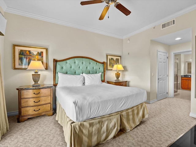 carpeted bedroom with connected bathroom, ornamental molding, and ceiling fan