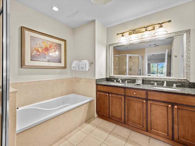 bathroom featuring a shower stall, a sink, a bath, double vanity, and tile patterned flooring