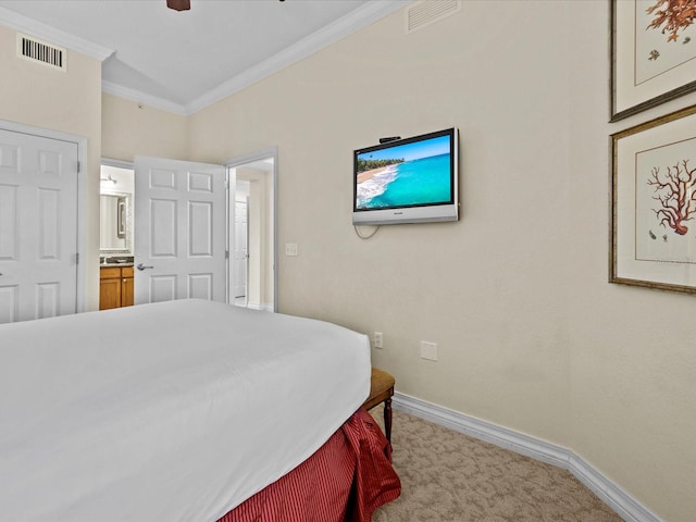 carpeted bedroom featuring crown molding, ceiling fan, and ensuite bathroom