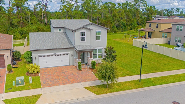 view of front of home featuring a garage and a front lawn