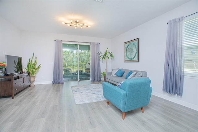 living room with light hardwood / wood-style flooring and a textured ceiling