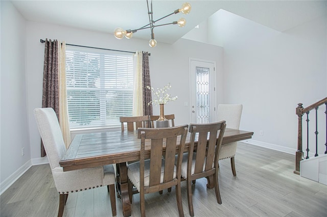 dining space with a notable chandelier and light wood-type flooring