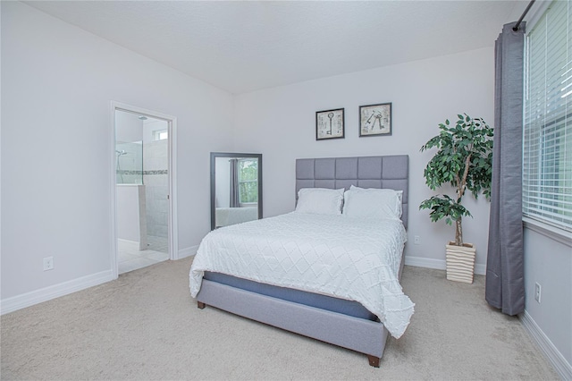 carpeted bedroom featuring ensuite bath