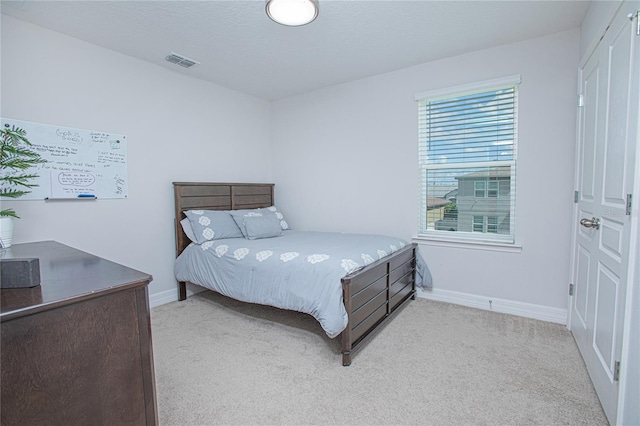 bedroom with light colored carpet