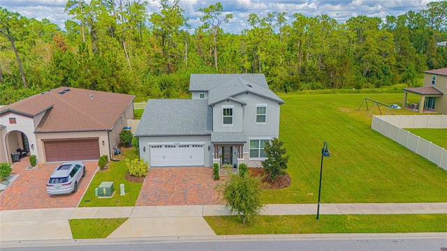 view of front facade featuring a front yard and a garage