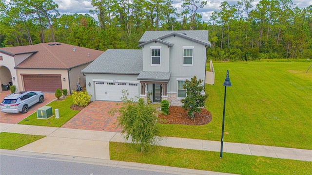 view of front facade with a garage and a front lawn