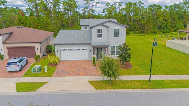 view of front facade featuring a garage and a front lawn