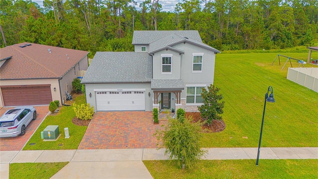 front of property with a front yard and a garage