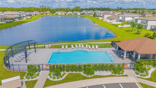 exterior space with a yard, a water view, and a patio area