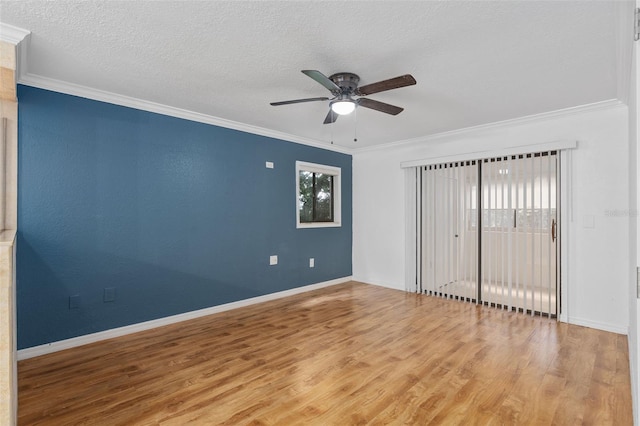 unfurnished bedroom with ornamental molding, wood-type flooring, ceiling fan, and a textured ceiling