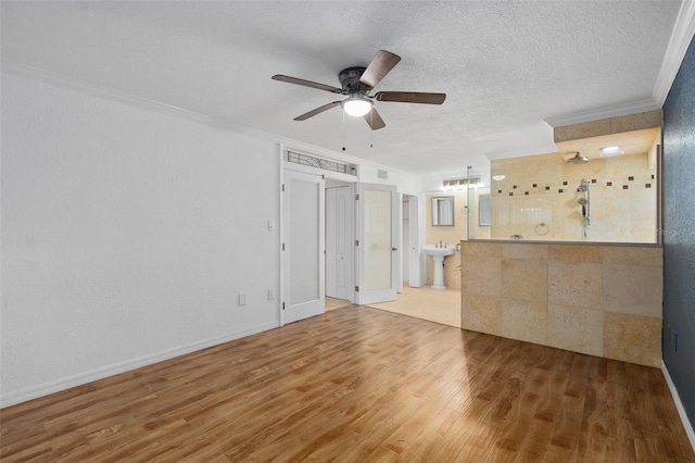 unfurnished living room with ornamental molding, ceiling fan, hardwood / wood-style floors, and a textured ceiling