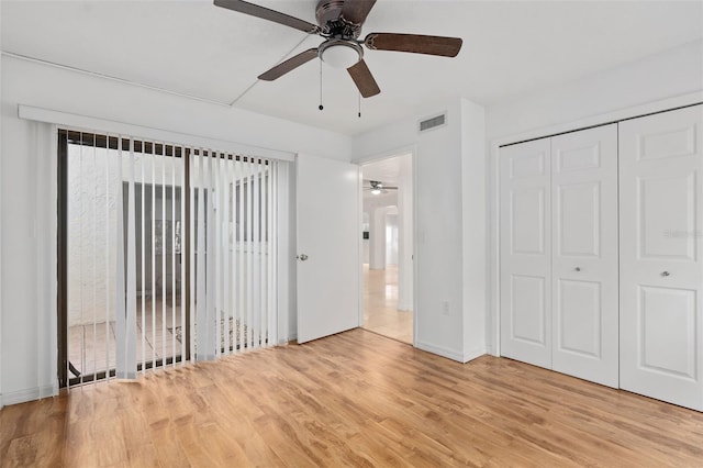 unfurnished bedroom with ceiling fan, light hardwood / wood-style flooring, and a closet