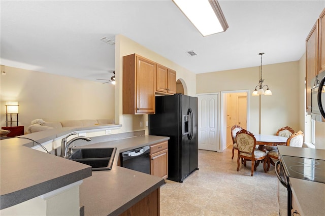 kitchen with pendant lighting, sink, ceiling fan with notable chandelier, kitchen peninsula, and black appliances