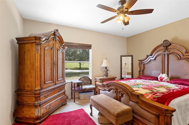 bedroom featuring light carpet and ceiling fan