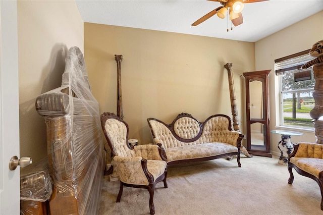 living area with carpet flooring and ceiling fan