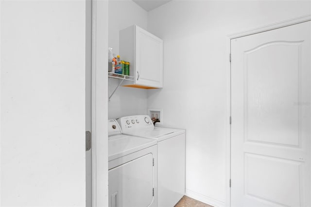 laundry area with separate washer and dryer and cabinets