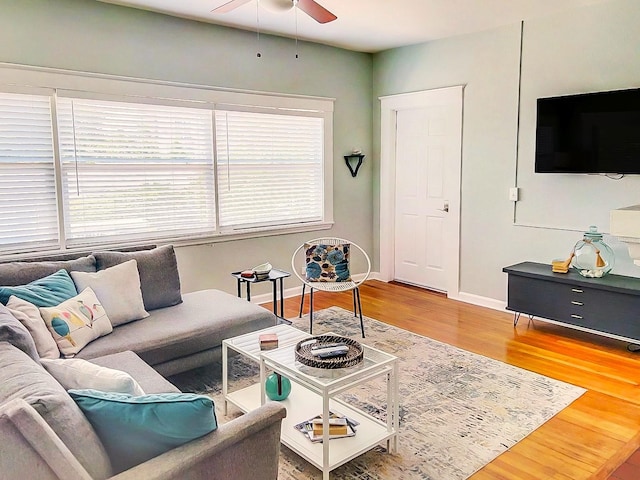 living room featuring wood-type flooring and ceiling fan